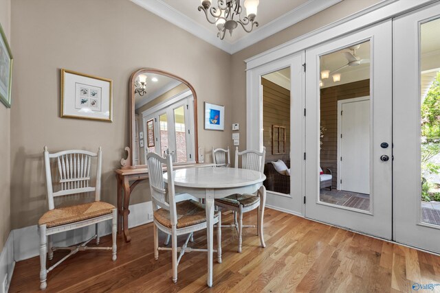9 Beck St NW, Huntsville, AL 35806 - dining area with a healthy amount of sunlight, crown molding, a notable chandelier, and french doors