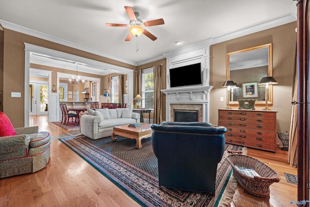 9 Beck St NW, Huntsville, AL 35806 - living room with ceiling fan with notable chandelier, plenty of natural light, wood finished floors, and ornamental molding