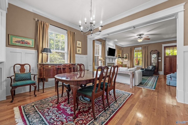 9 Beck St NW, Huntsville, AL 35806 - dining area featuring light wood-type flooring, a wealth of natural light, ornamental molding, and a decorative wall
