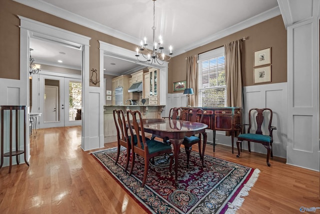 9 Beck St NW, Huntsville, AL 35806 - dining room with a decorative wall, ornamental molding, and an inviting chandelier