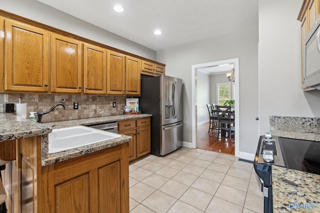 2801 Mountain View Dr, Southside, AL 35907 - kitchen featuring stainless steel fridge, brown cabinets, light tile patterned flooring, backsplash, and recessed lighting