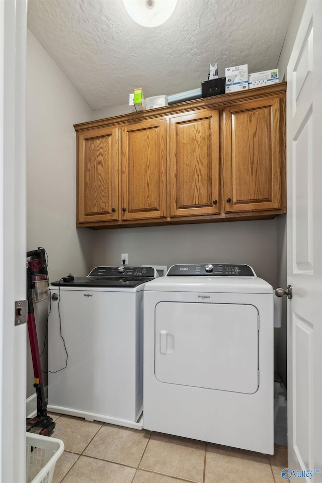2801 Mountain View Dr, Southside, AL 35907 - laundry room with cabinet space, separate washer and dryer, light tile patterned flooring, and a textured ceiling