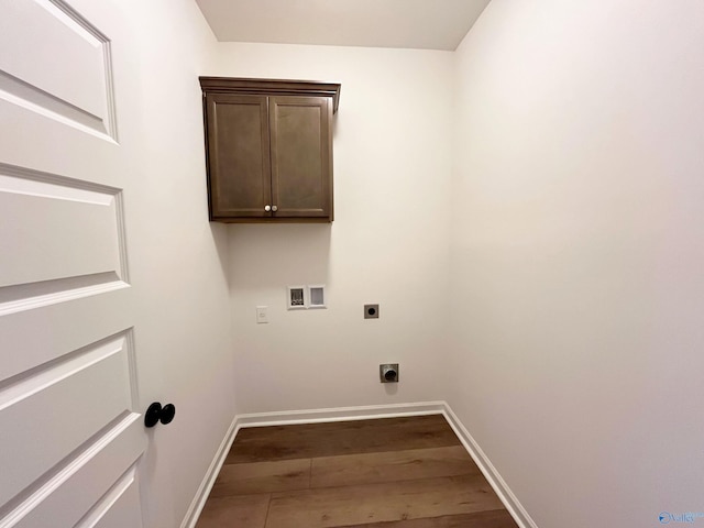 washroom featuring hookup for a washing machine, cabinet space, electric dryer hookup, wood finished floors, and baseboards