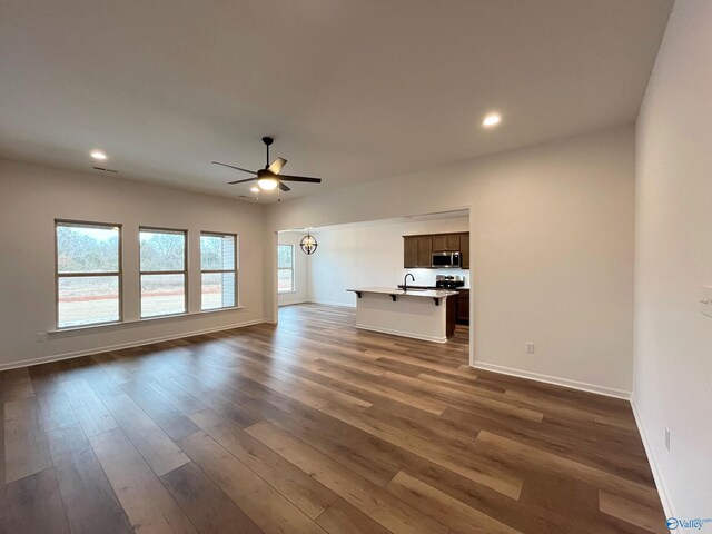 unfurnished living room featuring dark wood-style floors, recessed lighting, ceiling fan, and baseboards