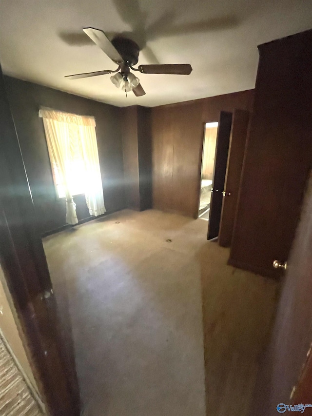 carpeted empty room featuring ceiling fan