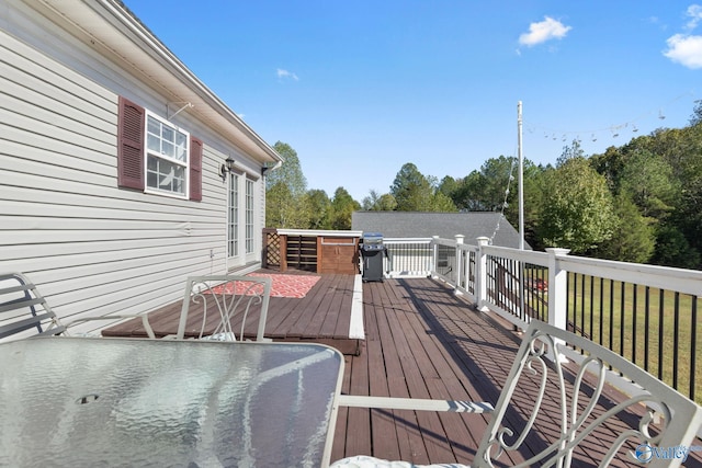 wooden deck featuring a grill