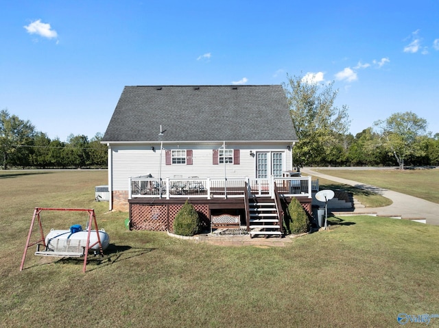 back of house with a wooden deck and a yard