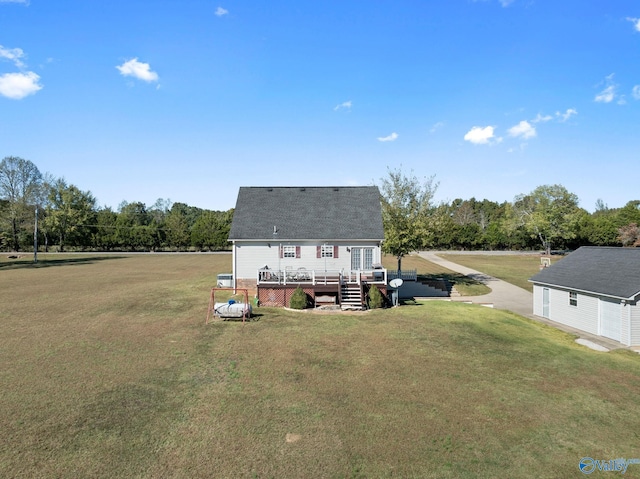 back of property featuring a yard and a deck