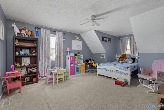 carpeted bedroom with lofted ceiling, a textured ceiling, and ceiling fan