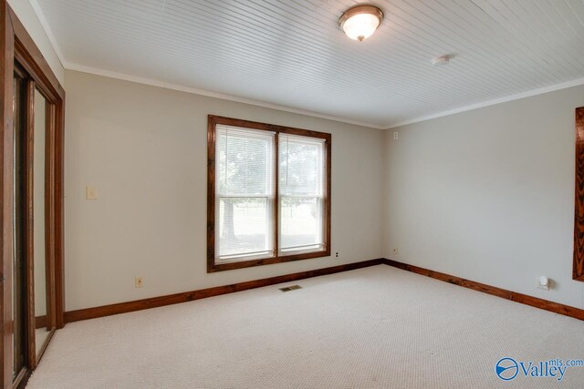 unfurnished room with light colored carpet, wooden ceiling, and crown molding