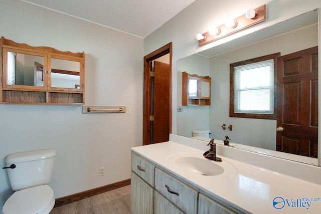 bathroom featuring hardwood / wood-style floors, vanity, and toilet