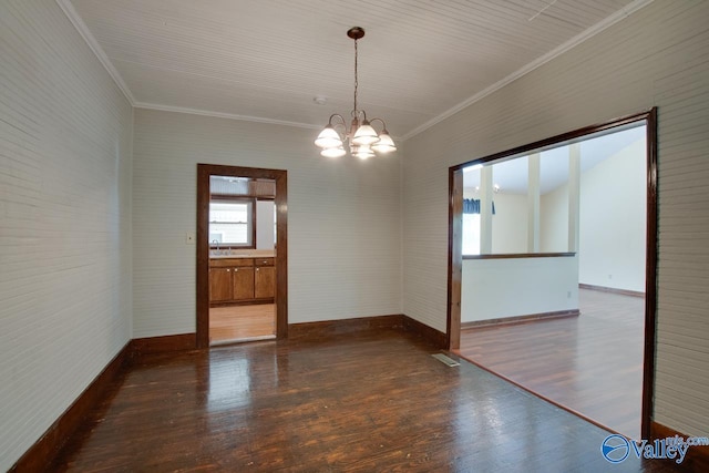 empty room with an inviting chandelier, dark hardwood / wood-style floors, and crown molding