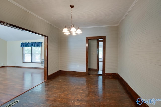 empty room with dark hardwood / wood-style floors, crown molding, and an inviting chandelier