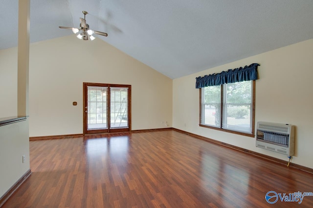 unfurnished living room with dark hardwood / wood-style flooring, heating unit, lofted ceiling, and ceiling fan