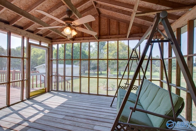 unfurnished sunroom featuring ceiling fan and vaulted ceiling