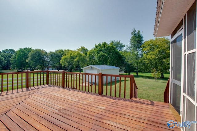 wooden deck featuring an outdoor structure and a yard