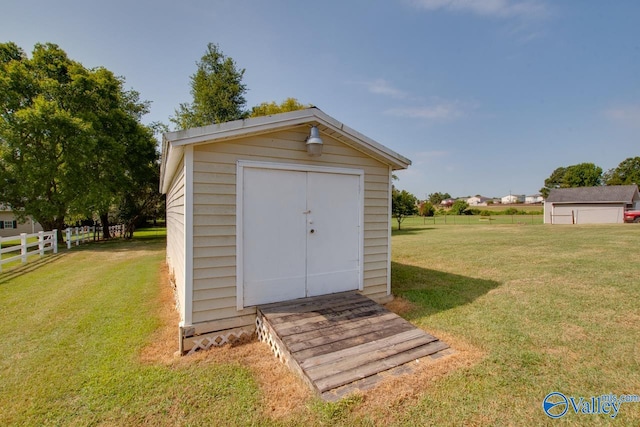 view of outbuilding featuring a lawn