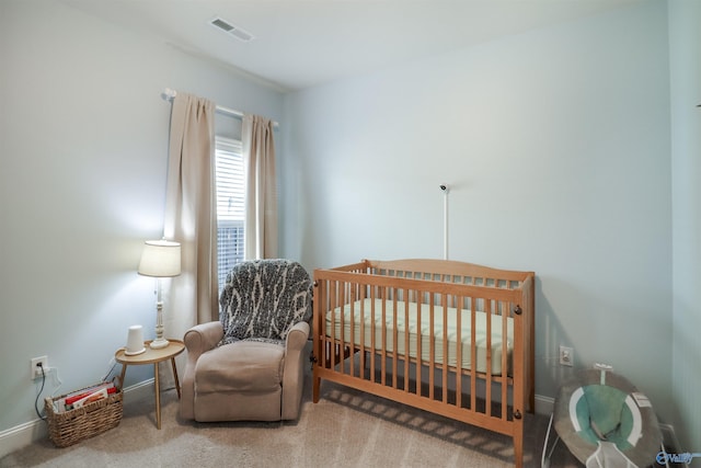 bedroom featuring carpet floors and a nursery area