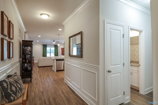 hall with hardwood / wood-style flooring and ornamental molding