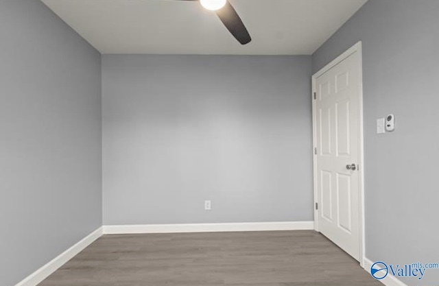 unfurnished room featuring wood finished floors, baseboards, and ceiling fan