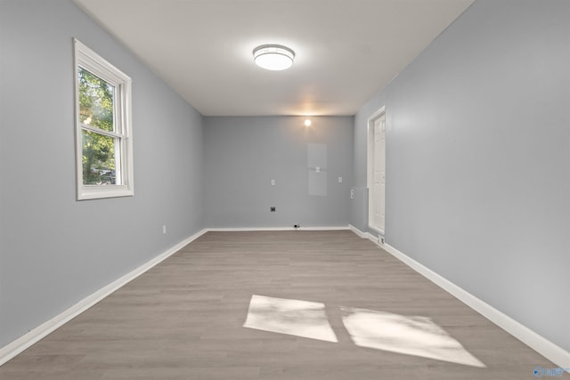 spare room with light wood-style flooring and baseboards