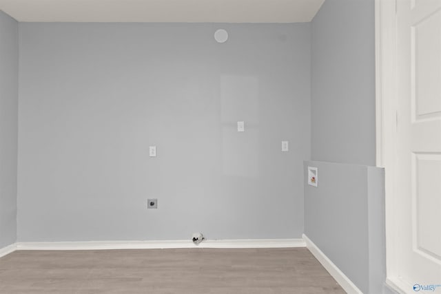 laundry area with laundry area, light wood-type flooring, baseboards, electric dryer hookup, and washer hookup