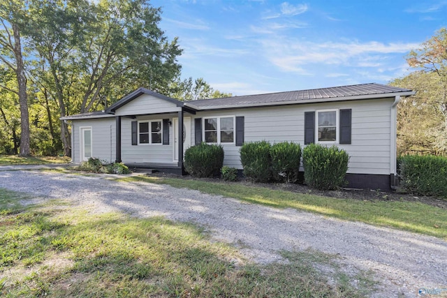 single story home featuring metal roof