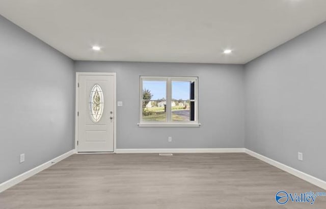 foyer entrance with recessed lighting, wood finished floors, and baseboards