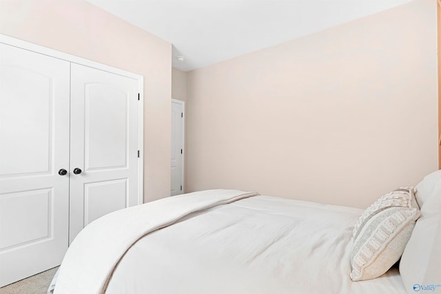 carpeted bedroom featuring a closet