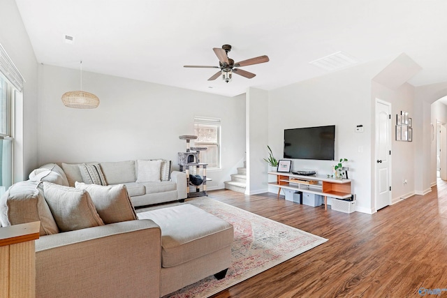 living room featuring ceiling fan, hardwood / wood-style floors, and a healthy amount of sunlight