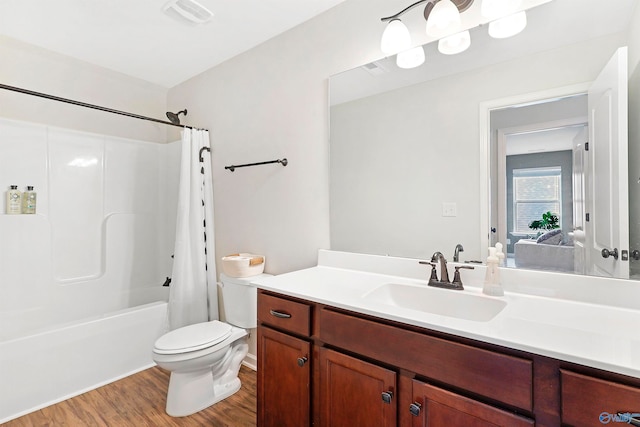 full bathroom featuring shower / bath combination with curtain, vanity, hardwood / wood-style floors, and toilet