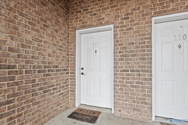 entrance to property with brick siding