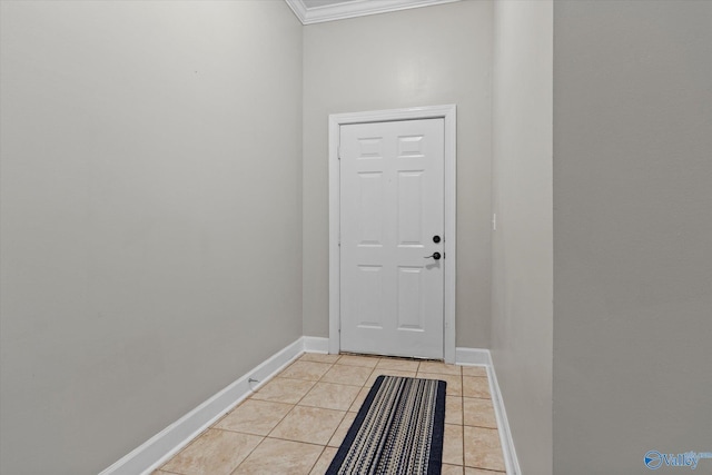doorway to outside featuring baseboards, ornamental molding, and light tile patterned flooring