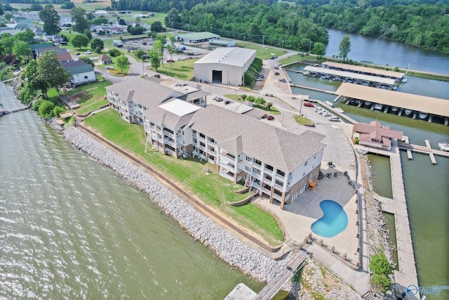 drone / aerial view featuring a water view and a view of trees