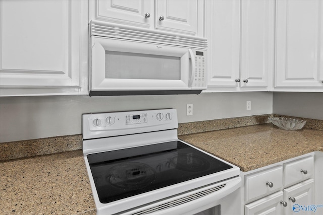 kitchen with white appliances and white cabinetry