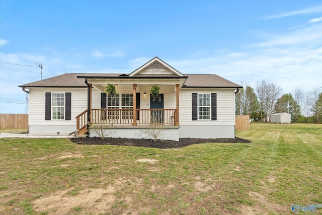 bungalow-style home featuring a front yard, covered porch, fence, and roof with shingles