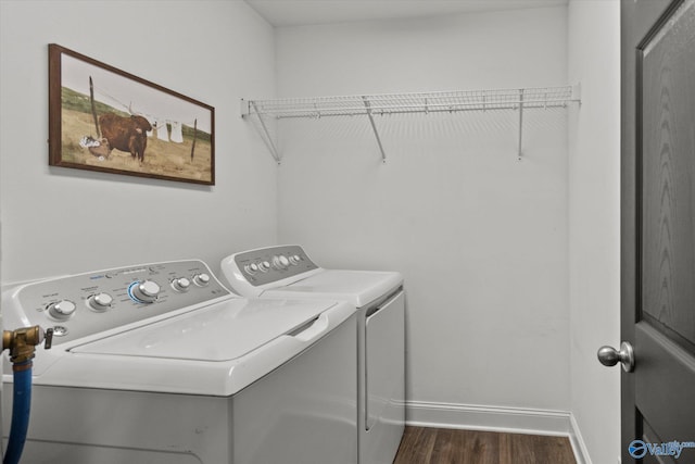 laundry room with washer and clothes dryer, laundry area, baseboards, and dark wood-style flooring