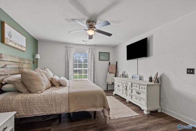 bedroom featuring a ceiling fan, dark wood-style floors, and baseboards