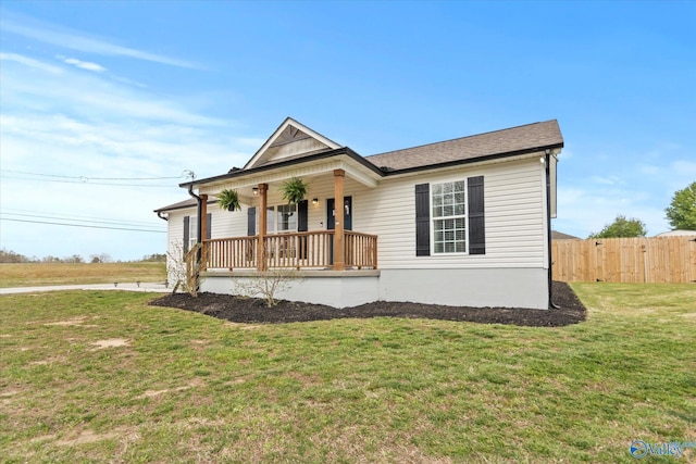 view of front of property featuring fence, a front yard, a porch, and roof with shingles