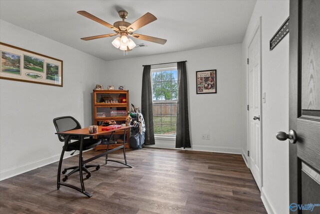 office with dark wood finished floors, baseboards, visible vents, and a ceiling fan