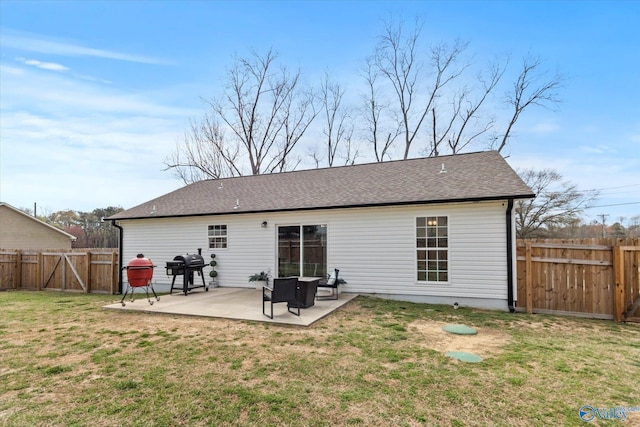 back of property featuring roof with shingles, a fenced backyard, a gate, a yard, and a patio area