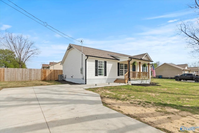 view of front of property with fence, a front lawn, covered porch, a shingled roof, and cooling unit