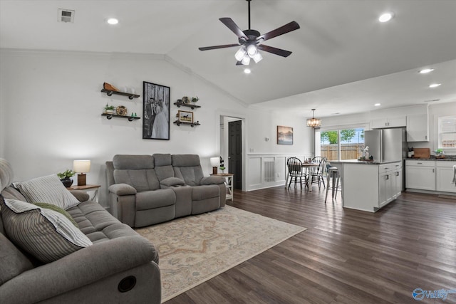 living area with vaulted ceiling, recessed lighting, ceiling fan with notable chandelier, dark wood finished floors, and visible vents
