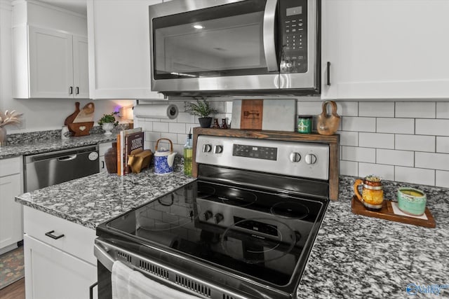 kitchen with white cabinets, decorative backsplash, stone counters, and stainless steel appliances