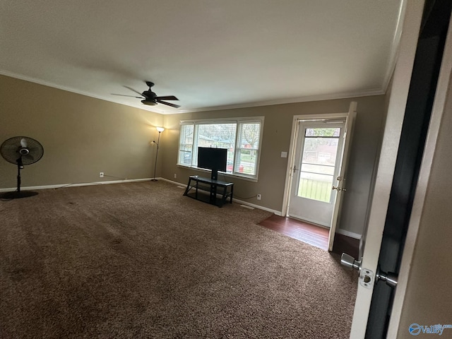 unfurnished living room featuring ornamental molding, carpet flooring, baseboards, and a ceiling fan