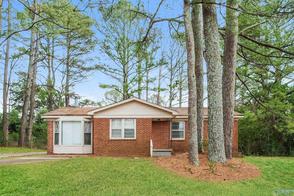 ranch-style home with a front lawn