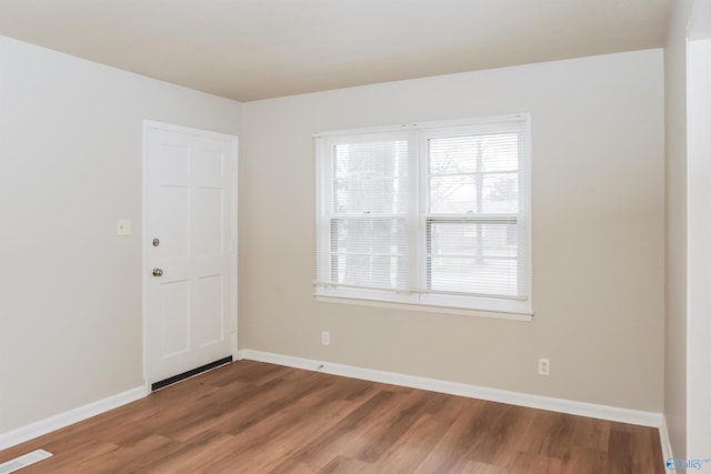 spare room with hardwood / wood-style flooring