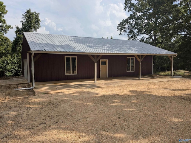 view of front of property featuring metal roof and a carport