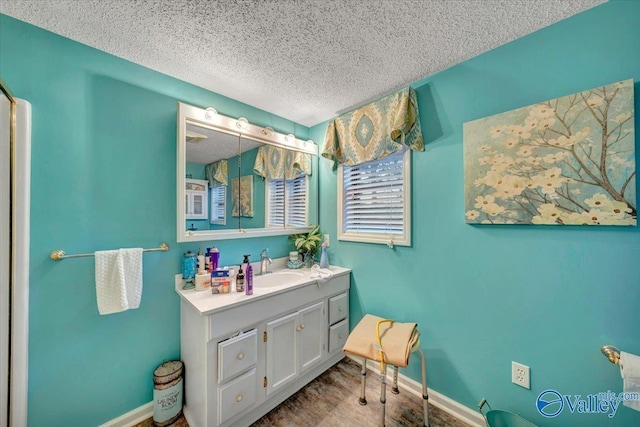 bathroom with a textured ceiling and vanity