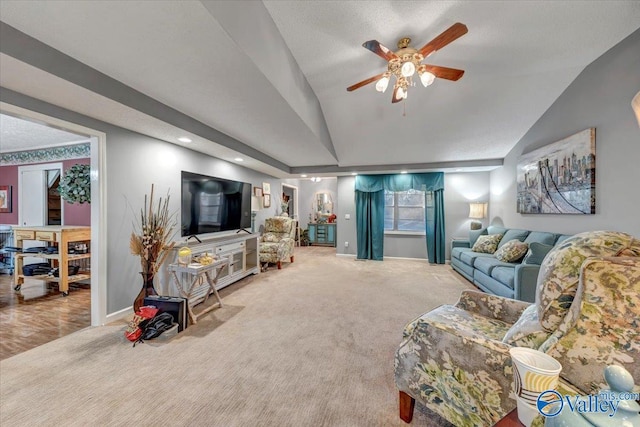 living room with vaulted ceiling, carpet, and ceiling fan